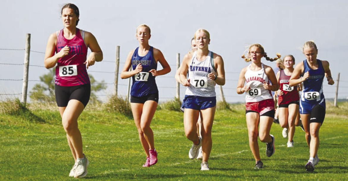 KATIE KLEINSASSER battles for position on Thursday at the Ravenna Invitational. Kleinsasser placed forty-eighth at the Bluejays’ meet. Photos by Michael Happ