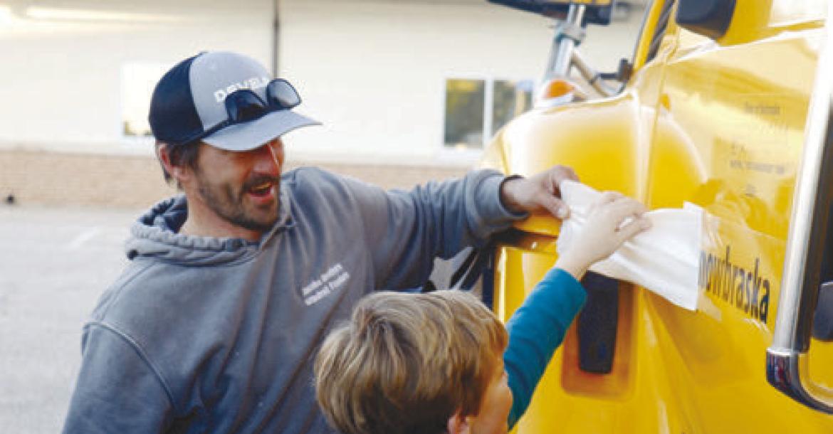 ST. PAUL ELEMENTARY SCHOOL Fourth Grader Elliot Egger helps unveil the new name of Plow 25008, Snowbraska. Egger and his classmate, Emma Platek, were winners in the Nebraska Department of Transportation’s Name-a-Snowplow contest. Photo by Michael Rother