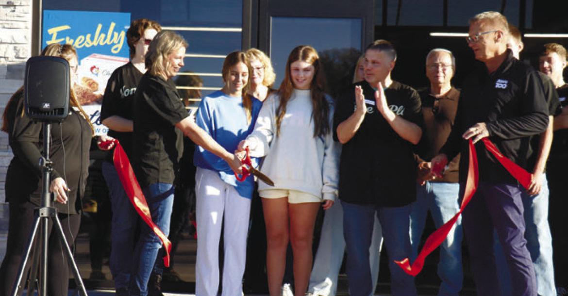 MEMBERS OF THE SCHWARTZ FAMILY cut the ribbon at Home Plate Market on Tuesday morning. Pictured cutting the ribbon are Liz, Ava, Perry, and Blake, and (back right) Dwayne Schwartz. Representatives with Associated Wholesale Grocers held the ribbon during the event. Photo by Michael Rother